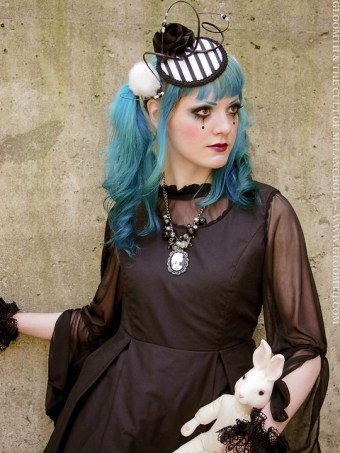 gothic outfit with taissa lada striped fascinator hat