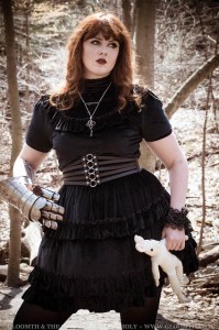 black velvet dress on a plus size model with steel armor gauntlet