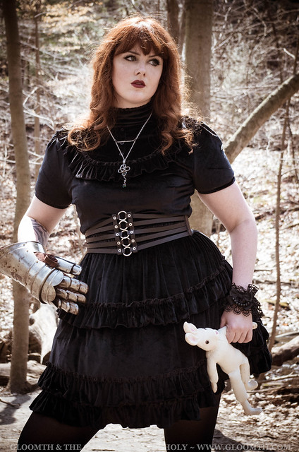black velvet dress on a plus size model with steel armor gauntlet