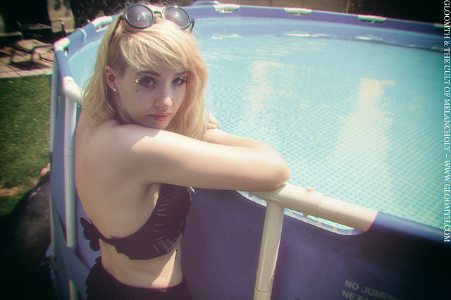gloomth swimwear model beside the pool