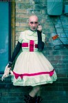 bald gothic woman in a nurse dress