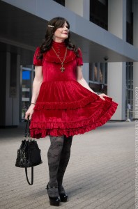 drag queen in red velvet gothic dress