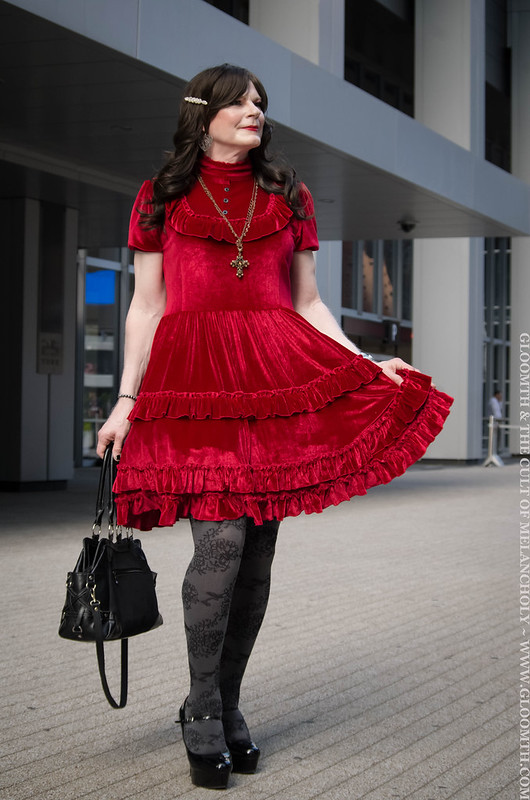 drag queen in red velvet gothic dress