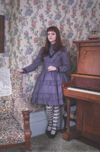 victorian girl beside a piano