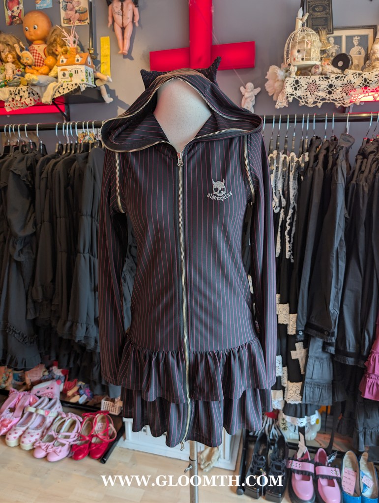 algonquins japan pinstripe dress on display in doll funeral shop toronto