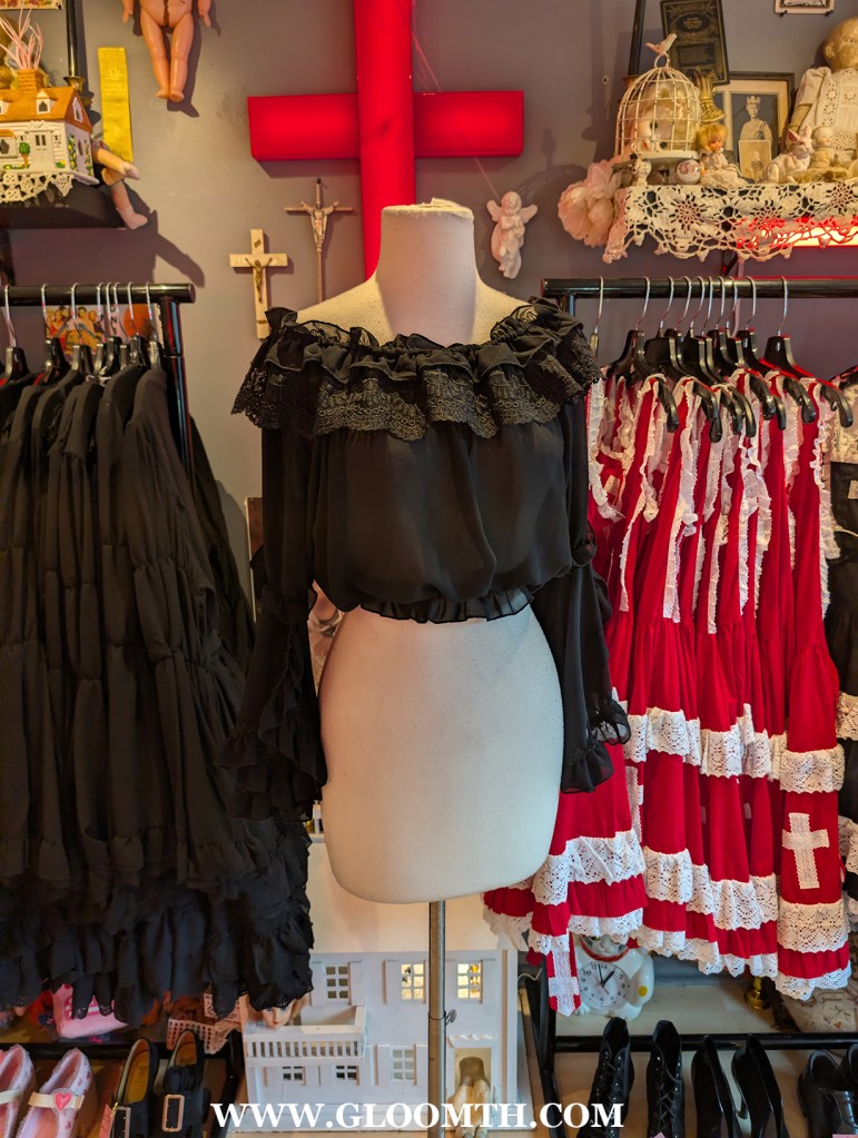 gothic lolita chiffon top on display inside doll funeral shop in toronto