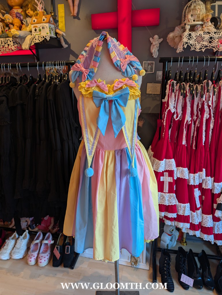 egglien pastel clown set displayed on a mannequin inside doll funeral shop in toronto